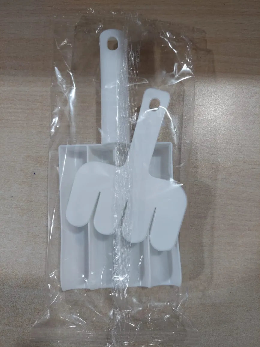 White plastic spatula set in clear packaging on a wooden surface