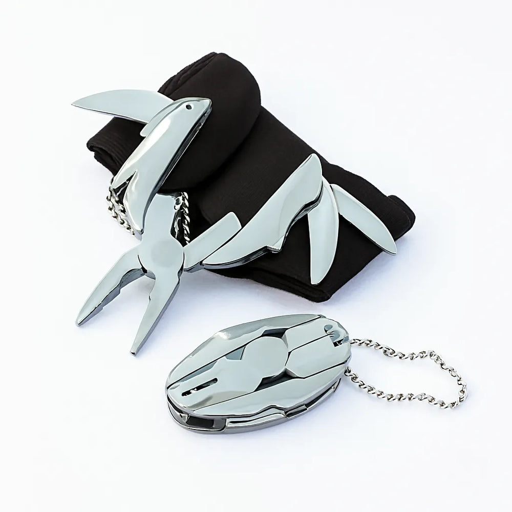 Metallic shark-shaped keychain and carabiner on a white background