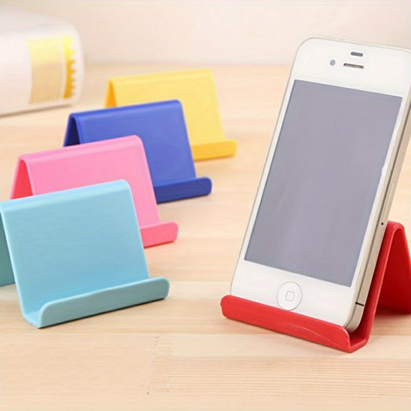 Colorful phone stands on a wooden surface with a smartphone on one of them.