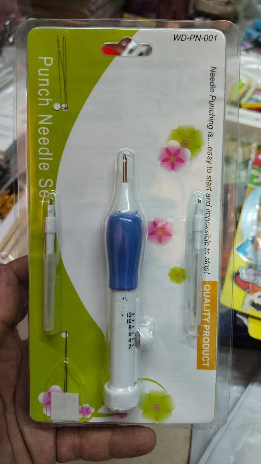 Punch needle set on a packaging card with floral design