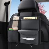 Car back seat organizer with phone, butter package, and other items in a vehicle.