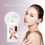 Smartphone with a ring light attached, showing a woman's face on the screen against a plain background.