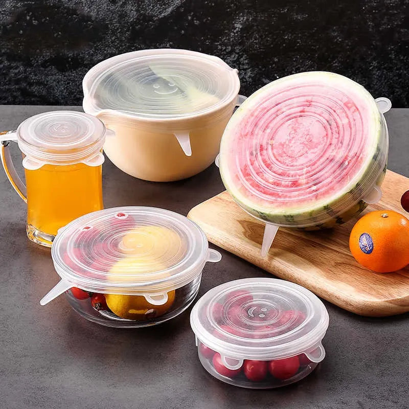 Silicone food covers on various containers including a watermelon, fruits, and a glass of juice.