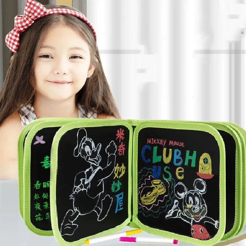 Child holding a blackboard with colorful drawings and text, including 'Mickey Mouse Clubhouse'.