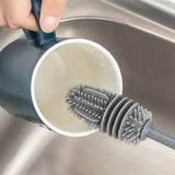 Silicone bottle brush with an extended handle for reaching the bottom of bottles and containers.