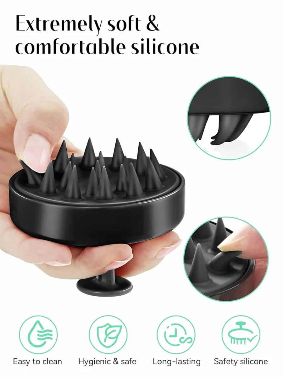 Black silicone scalp massager held by a hand with close-up details on a white background.