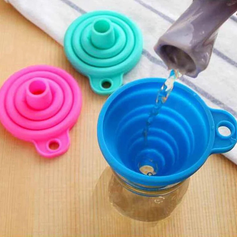 Collapsible silicone cup with colorful lids on a wooden surface