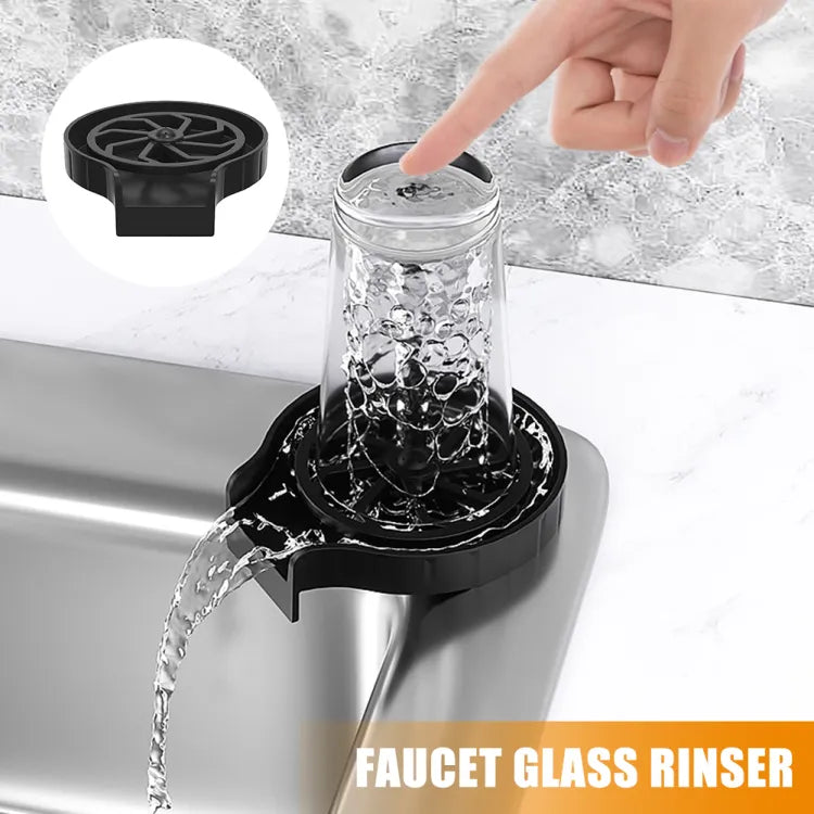 Faucet glass ringer with water flowing into a glass, set against a marble countertop.