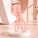 Pink handheld device on a white platform 