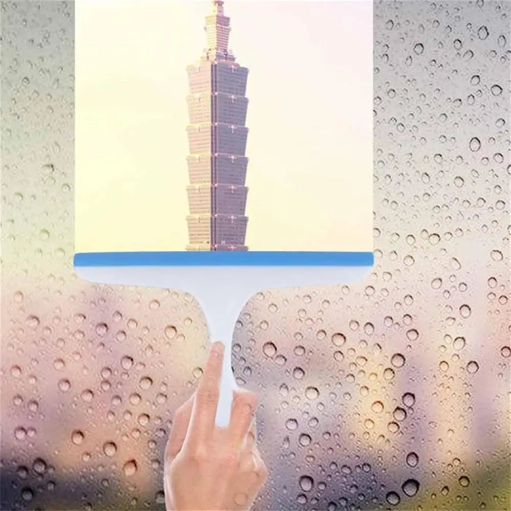 Hand holding a transparent object with a cityscape in the background