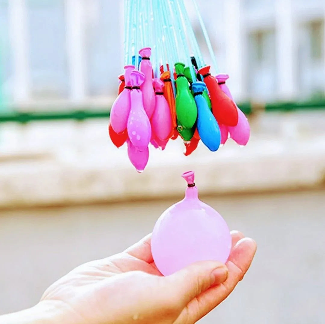 Colorful water balloons being held by a hand with a blurred background