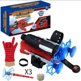 Spider-Man themed toy launch set with a black and red toy blaster, blue suction-cup web shooters, a red glove, a web line spool, a wrist strap, and the retail box on a white background.
