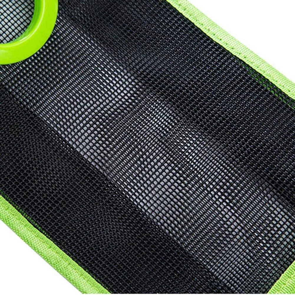 Close-up of a black mesh or foam pad with bright neon green trim and a matching green circular ring or handle visible in the top-left corner.