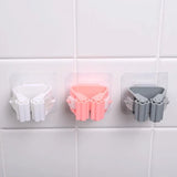 Wall-mounted cleaning tool holder for organizing mops, brushes, and household cleaning accessories.