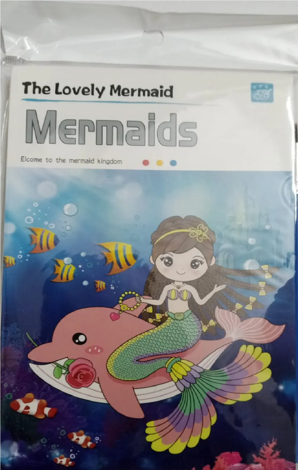 A packaged children's book or booklet titled "The Lovely Mermaid Mermaids" with colorful underwater artwork showing a mermaid riding a pink dolphin, surrounded by fish and bubbles.
