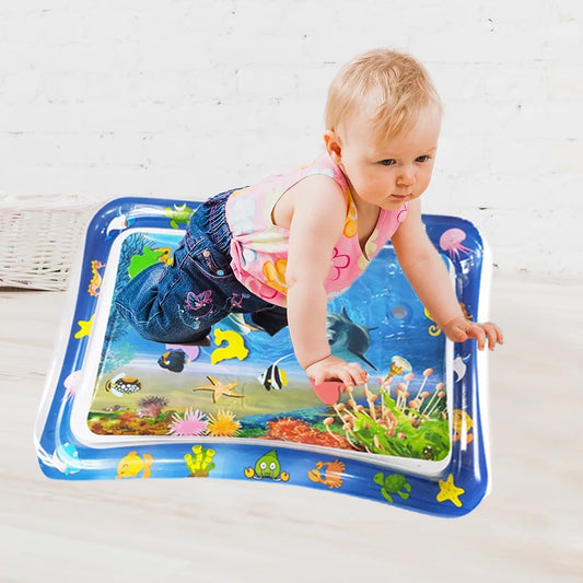 Child playing on an inflatable water mat with colorful designs 