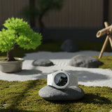 White watch on a stone in a zen garden setting